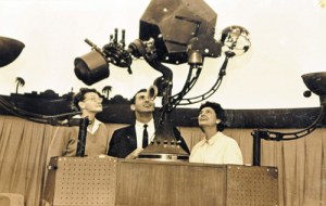 Ernestine Gilliland, Denny Stevens and Patty Carey all look at the Spitz A-2 star projector in an old photo from Patty Carey’s scrapbook of the Hutchinson Planetarium, which started in the Poultry Exhibit building at the Kansas State Fair in 1962.